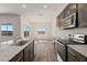 Gourmet kitchen with granite counters, island, and modern appliances opens to living space at 652 W Pintail Dr, Casa Grande, AZ 85122