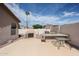 Backyard space with a built-in BBQ, fireplace, and an outdoor dining table at 656 W Johnson Dr, Gilbert, AZ 85233