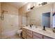 Well-lit bathroom featuring dual sinks, a large mirror, and a shower-tub combo at 656 W Johnson Dr, Gilbert, AZ 85233