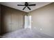 Neutral bedroom featuring plush carpet, ceiling fan, closet, and neutral color walls at 656 W Johnson Dr, Gilbert, AZ 85233