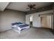 Spacious bedroom with neutral tones, carpet flooring, ceiling fan, and en-suite bathroom and walk-in closet at 656 W Johnson Dr, Gilbert, AZ 85233