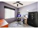 A small bedroom with a desk, computer, ceiling fan, and a window at 656 W Johnson Dr, Gilbert, AZ 85233
