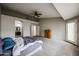 Large bedroom with a ceiling fan, carpet floor, and access to the bathroom and a door to the backyard at 656 W Johnson Dr, Gilbert, AZ 85233
