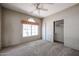 Bedroom with neutral carpet, ceiling fan, window, and closet at 656 W Johnson Dr, Gilbert, AZ 85233
