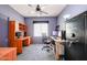 A small bedroom with a desk, computer, ceiling fan, and a window at 656 W Johnson Dr, Gilbert, AZ 85233