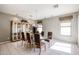 A dining room features a glass table and patterned purple chairs at 656 W Johnson Dr, Gilbert, AZ 85233