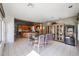 A dining room features an open floor plan and a chandelier hanging above a glass table at 656 W Johnson Dr, Gilbert, AZ 85233