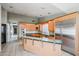 Spacious kitchen with stainless steel appliances, light wood cabinetry, and a glass-top island at 656 W Johnson Dr, Gilbert, AZ 85233