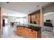A spacious kitchen features wood cabinets, a black countertop island, and an open floor plan at 656 W Johnson Dr, Gilbert, AZ 85233