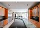 A modern kitchen featuring light wood cabinets, an island with a black countertop and stainless steel appliances at 656 W Johnson Dr, Gilbert, AZ 85233