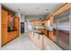 A modern kitchen featuring light wood cabinets, an island with a black countertop and stainless steel appliances at 656 W Johnson Dr, Gilbert, AZ 85233
