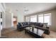 Bright living room featuring plush carpet, a ceiling fan, and a large sectional sofa for comfortable seating at 656 W Johnson Dr, Gilbert, AZ 85233