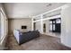 Spacious living room with plush carpet, a large sectional sofa, and an open entryway for easy flow at 656 W Johnson Dr, Gilbert, AZ 85233