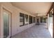Covered patio with tile flooring, multiple windows, and outdoor ceiling fan at 656 W Johnson Dr, Gilbert, AZ 85233