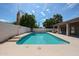 Sparkling backyard pool with lush landscaping and a covered patio, perfect for entertaining and relaxing at 656 W Johnson Dr, Gilbert, AZ 85233