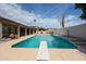 Beautiful backyard pool with diving board, lush landscaping, and a covered patio, perfect for outdoor entertaining at 656 W Johnson Dr, Gilbert, AZ 85233