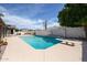 Beautiful pool with a diving board, surrounded by lush landscaping and privacy walls at 656 W Johnson Dr, Gilbert, AZ 85233