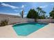 Beautiful backyard pool with tiled edge, mature trees, and desert landscaping at 656 W Johnson Dr, Gilbert, AZ 85233