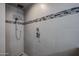 Close-up shot of a gray tiled walk-in shower featuring a rainfall shower head and handheld sprayer at 656 W Johnson Dr, Gilbert, AZ 85233