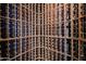 An empty wood wine cellar with lattice style shelving and space for wine bottles at 656 W Johnson Dr, Gilbert, AZ 85233