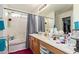 Well-lit bathroom with single sink and white tiled bath/shower combination at 7215 N 76Th Ave, Glendale, AZ 85303