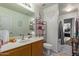 Bathroom with vanity, toilet, and decorative shelving, combining style with functionality at 7215 N 76Th Ave, Glendale, AZ 85303