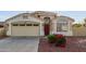 Charming home showcasing a two-car garage, well maintained landscape, and inviting front entrance at 7215 N 76Th Ave, Glendale, AZ 85303