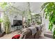 Airy living space filled with lush indoor plants, comfortable seating, and lots of natural light for relaxation at 7215 N 76Th Ave, Glendale, AZ 85303