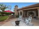 Outdoor living space with patio, grill, and chairs by the manicured lawn at 7517 E Mariposa Grande Dr, Scottsdale, AZ 85255