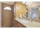 Bathroom featuring a large vanity with granite countertop, a mirrored cabinet, and a glass-enclosed shower at 7517 E Mariposa Grande Dr, Scottsdale, AZ 85255