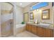 Elegant bathroom with dual sinks, tiled floors, walk-in shower, and a soaking tub at 7517 E Mariposa Grande Dr, Scottsdale, AZ 85255