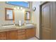 Well-lit bathroom featuring dual sinks with granite countertops and a private toilet room at 7517 E Mariposa Grande Dr, Scottsdale, AZ 85255