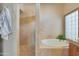 Spacious bathroom showcasing a separate shower and soaking tub, along with tile flooring at 7517 E Mariposa Grande Dr, Scottsdale, AZ 85255