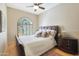 Cozy bedroom features a large window, plush carpet, and a comfortable bed with stylish side table at 7517 E Mariposa Grande Dr, Scottsdale, AZ 85255