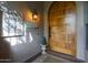Inviting front entrance featuring a solid wood door, decorative lighting, and a welcoming atmosphere at 7517 E Mariposa Grande Dr, Scottsdale, AZ 85255