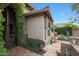 Close-up of the inviting front porch area, complete with stone accents, tiled walkway, and desert landscaping at 7517 E Mariposa Grande Dr, Scottsdale, AZ 85255