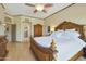 Spacious main bedroom with wood floors, ceiling fan, and view into the ensuite bathroom at 7517 E Mariposa Grande Dr, Scottsdale, AZ 85255