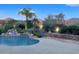 Beautiful pool featuring a rock waterfall, lush landscaping, and ample deck space for relaxing and entertaining at 7517 E Mariposa Grande Dr, Scottsdale, AZ 85255