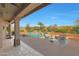 Charming backyard with a pool, lush landscaping, and covered patio area at 7517 E Mariposa Grande Dr, Scottsdale, AZ 85255