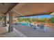 Inviting backyard with a shimmering pool, rock features, and covered patio at 7517 E Mariposa Grande Dr, Scottsdale, AZ 85255
