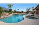 Sparkling pool and hot tub area with rock waterfall, lush greenery, and serene backyard views at 7517 E Mariposa Grande Dr, Scottsdale, AZ 85255