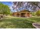 Lovely backyard showcasing a covered patio and sprawling lawn with mature shade trees at 823 W Palo Verde Dr, Phoenix, AZ 85013