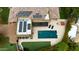 Aerial view of a pool area with a hot tub, solar panels, and lush landscaping in the backyard at 823 W Palo Verde Dr, Phoenix, AZ 85013
