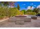 Backyard spa and fire pit with mature landscaping and easy access to the pool and patio area at 823 W Palo Verde Dr, Phoenix, AZ 85013