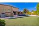 Spacious backyard with a pool, artificial turf, lounge chairs, and an outdoor kitchen area at 823 W Palo Verde Dr, Phoenix, AZ 85013