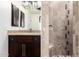 Elegant bathroom features a shower with decorative tile, a vanity with granite counters and a framed mirror at 823 W Palo Verde Dr, Phoenix, AZ 85013