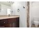 Bathroom features a shower with decorative tile, a vanity with granite counters and a framed mirror at 823 W Palo Verde Dr, Phoenix, AZ 85013