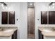 Dual vanities and a central shower stall make for a useful and luxurious bathroom at 823 W Palo Verde Dr, Phoenix, AZ 85013