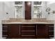 Lavish bathroom features dual sinks, marble countertops, and dark wood cabinets with modern fixtures at 823 W Palo Verde Dr, Phoenix, AZ 85013
