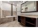 Luxurious bathroom features a tiled tub, dark wood cabinets and modern fixtures at 823 W Palo Verde Dr, Phoenix, AZ 85013
